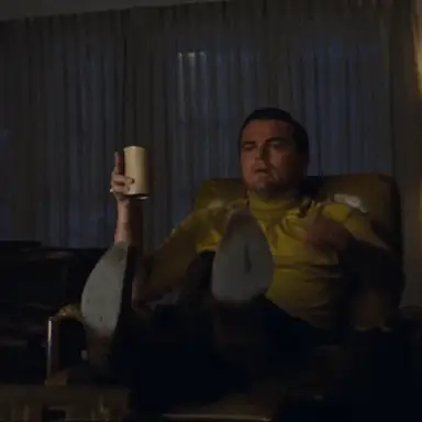 Leonardo DiCaprio pointing excitedly at a television